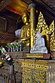Buddha statue and decorations in ordination hall (thein) in teak Shwe Yaunghwe Kyaung Buddhist monastery, near Inle Lake. Myanmar.